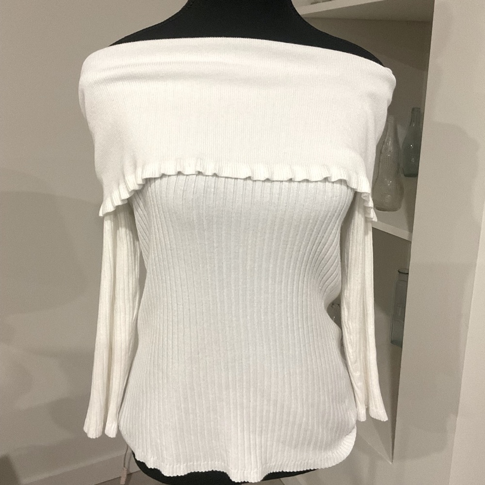Cute white off the shoulder Sweater with Ruffled neckline.